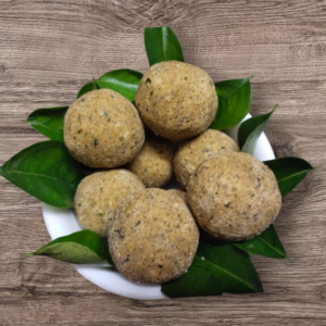 Close-up of Karuvepillai Laddu showing texture and natural ingredients.