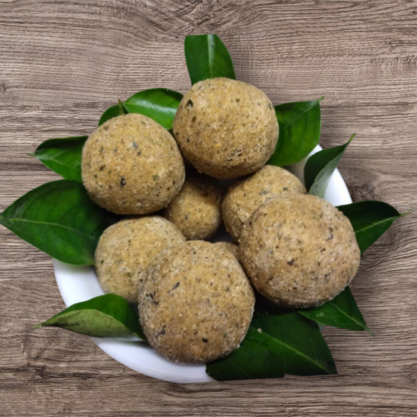 Close-up of Karuvepillai Laddu showing texture and natural ingredients.